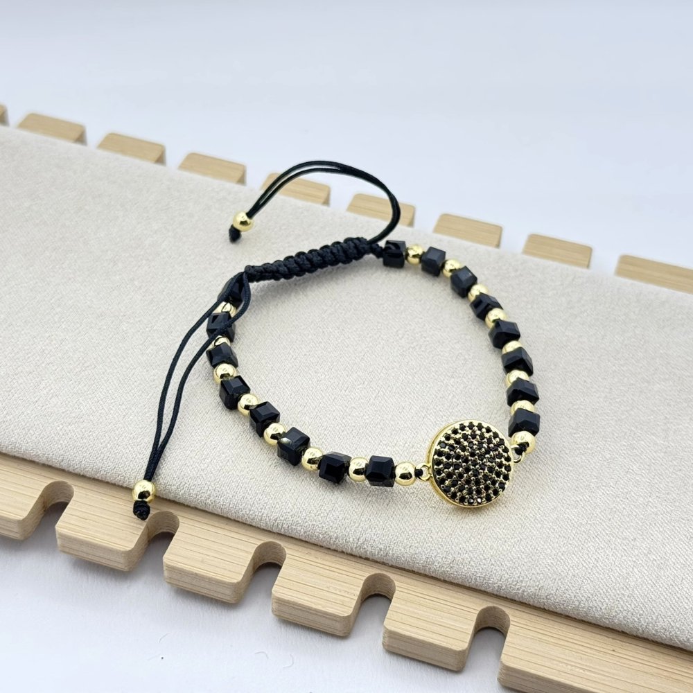 Bratara pe snur cerat cu bilute negre si aurii